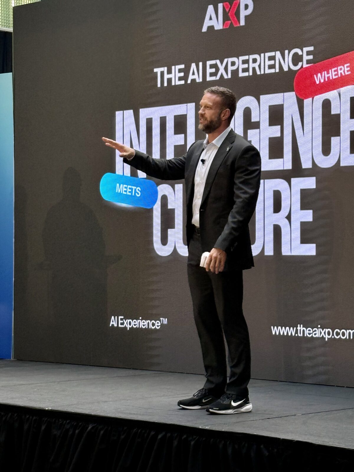Speaker presenting to a full room at AIXP